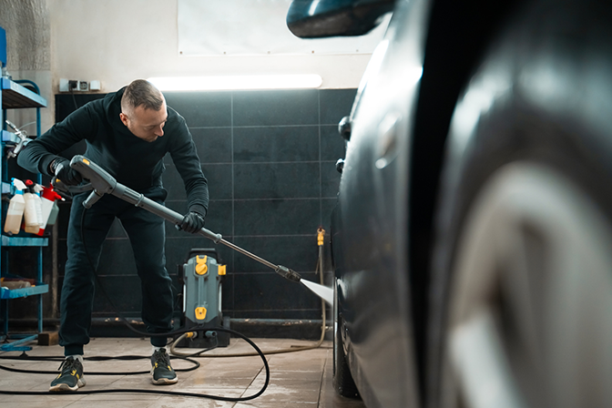 Car wash attendant wash a car's wheels